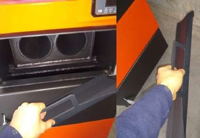 Installer sliding the flame bumper deflector plate into the boiler through the open upper door